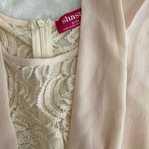 Tan lace romper that zips up from the back.